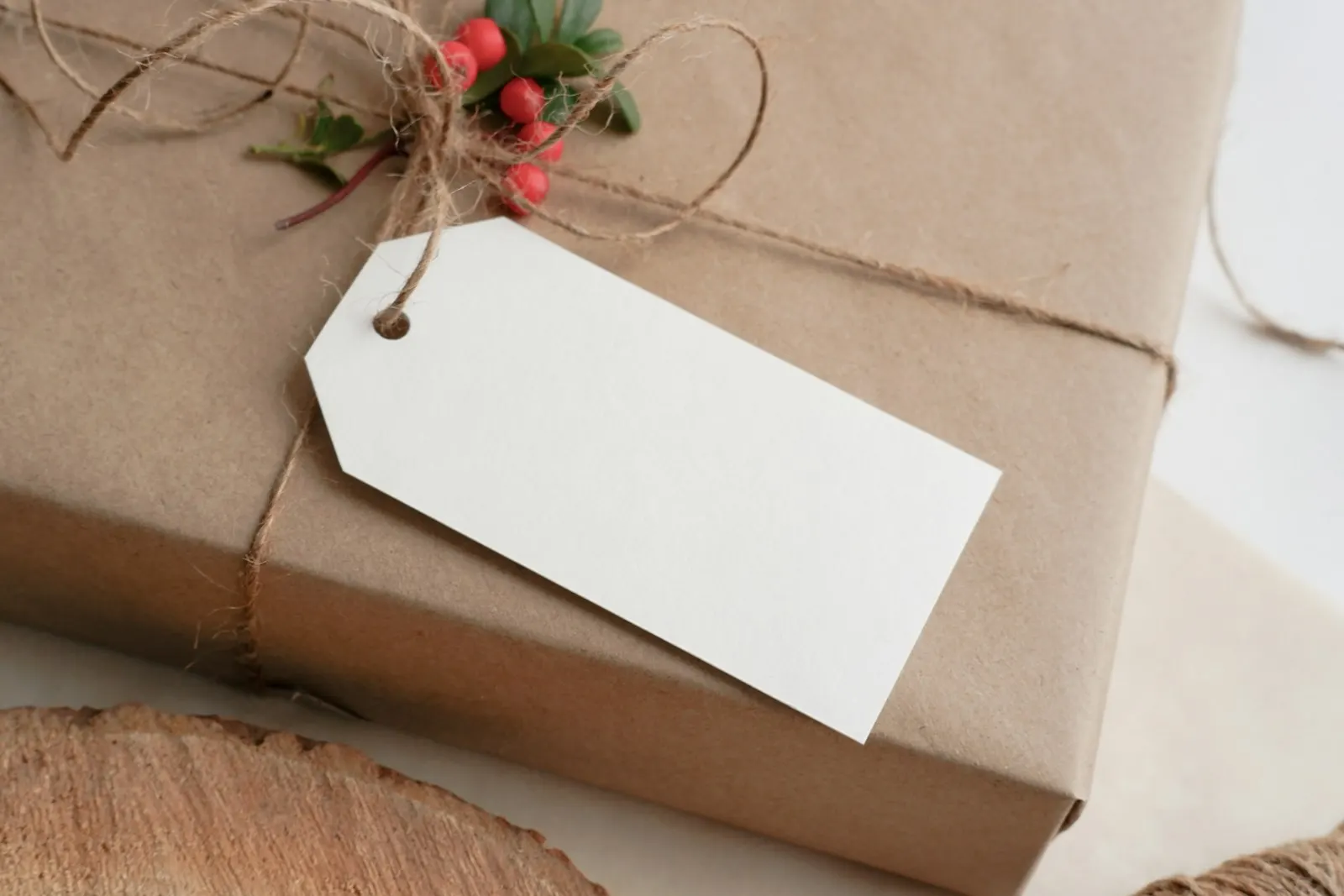 A present wrapped in brown kraft paper and twine, with a blank gift tag