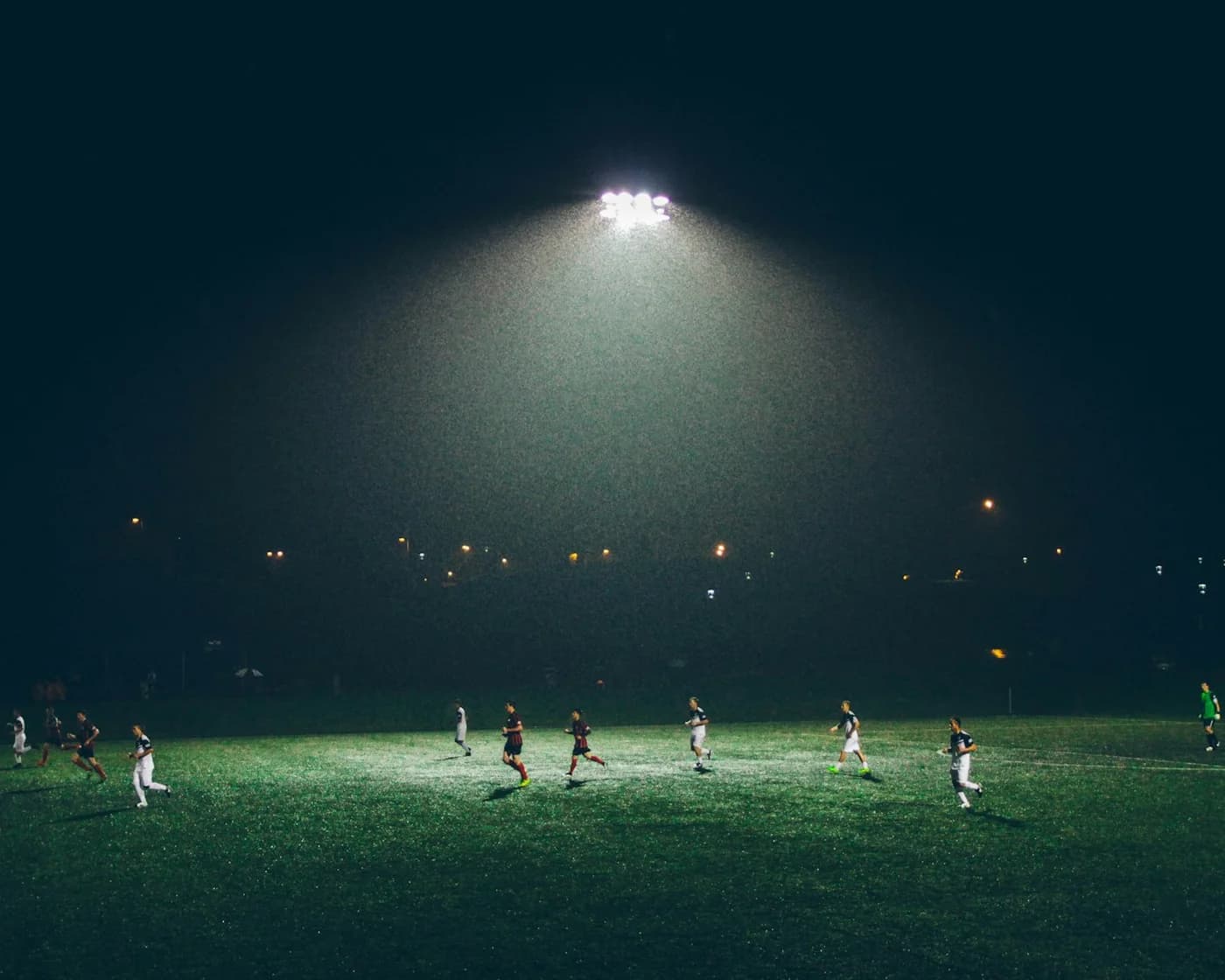 Soccer match under stadium floodlights at night